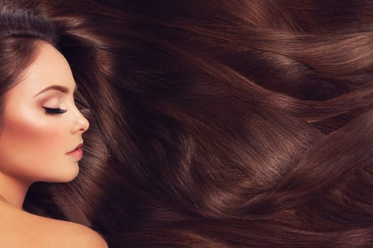 Profile of beautiful woman with long silky brown hair