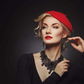 Beautiful lady in red beret. Beauty portrait. Red lips. Over black background. Copy space.