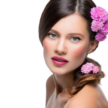 Beautiful young woman with pink flowers. Beauty shot. Isolated over white background. Copy space.