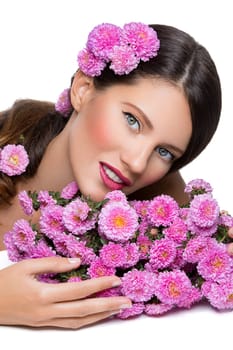 Beautiful young woman with pink flowers. Beauty shot. Isolated over white background. Copy space.