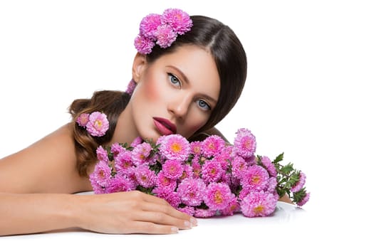 Beautiful young woman with pink flowers. Beauty shot. Isolated over white background. Copy space.