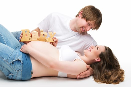 Young beautiful happy parents expecting their first child. Isolated over white background