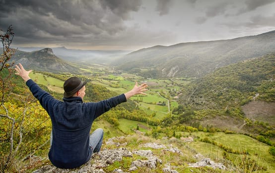 young man looking at the mountain at sunset