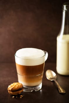 Cup of hot Cappuccino Coffee on dark background.