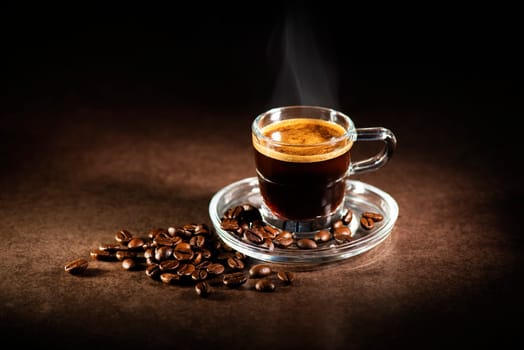 Cup of espresso coffee on dark background.