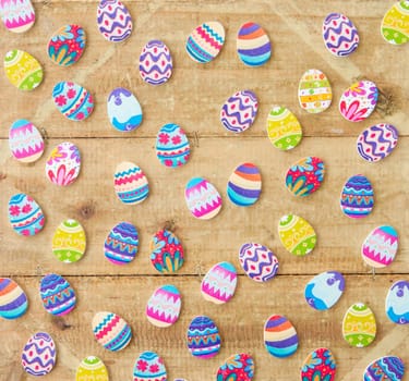 Colorful eggs on rustic wood as a background for Easter