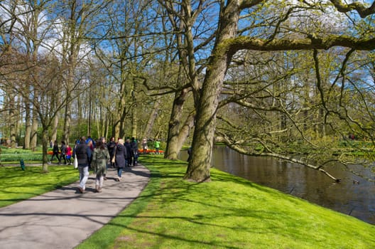 LISSE, NETHERLANDS - APRIL 17, 2016: Unknown tourists visiting the famous keukenhof tulip gardens in the netherlands