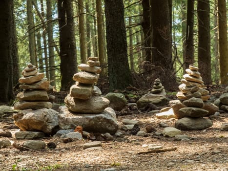 Group of cairns (colloquially: Steinmännchen) on a mountain hiking trail in South Tyrol above Merano in summer.