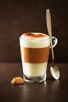 Glass of hot Latte macchiato coffee close up.