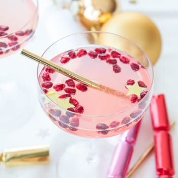 Pink cocktail with pomegranate and Christmas decorations