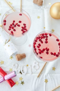 Pink cocktail with pomegranate and Christmas decorations