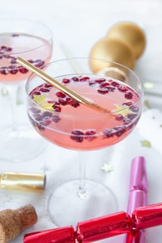 Pink cocktail with pomegranate and Christmas decorations