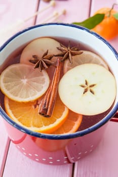 Homemade winter punch with oranges and waxes