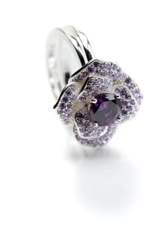 Silver ring with a purple stone. Isolated on white.