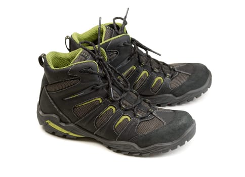 Pair of modern high-tech winter trekking shoes. Isolate on white.