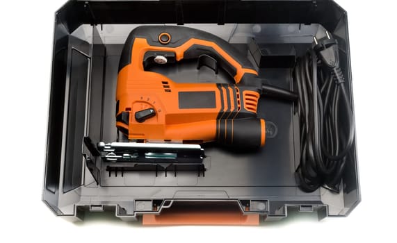 Electric jigsaw in plastic case on a white background.