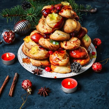 croquembouche cake decorated with caramel threads and cranberries with the marmalade