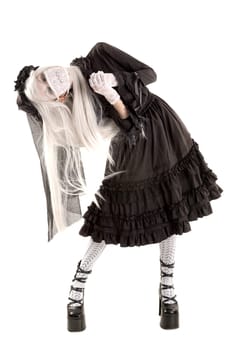 Widow in a black dress with white eyes looking like a doll isolated in white