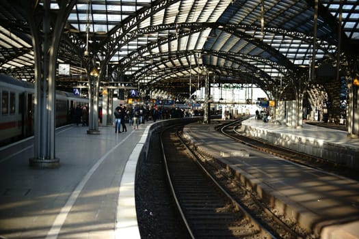 Cologne,Germany - November 24,2016: Passengers stand at a railway track of Cologne Central Station under a glass canopy on November 24,2016 in Cologne.