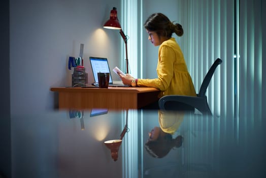 Young woman with laptop computer for homework. Tired hispanic girl and college education. Female student studying and using pc at home