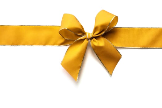 Gold satin ribbon and bow isolated on white