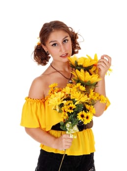 Gorgeous young woman in a yellow blouse holding a bunch of .sunflowers, smiling, standing isolated for white background..