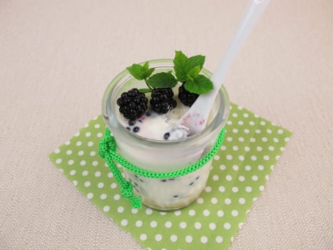 Baked yogurt with blackberries in a glass