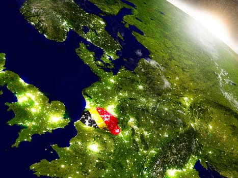 Belgium with embedded flag on planet surface during sunrise. 3D illustration with highly detailed realistic planet surface and visible city lights. Elements of this image furnished by NASA.