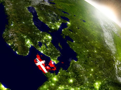 Denmark with embedded flag on planet surface during sunrise. 3D illustration with highly detailed realistic planet surface and visible city lights. Elements of this image furnished by NASA.