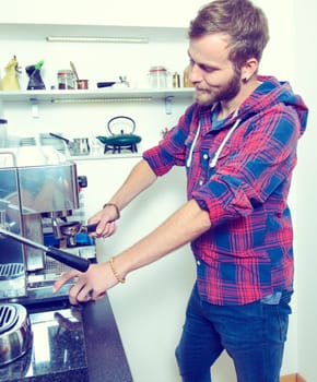 man using espresso metallic machine with portafilter