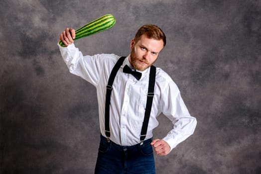 young angry vegetarian minatory with zucchini cudgel