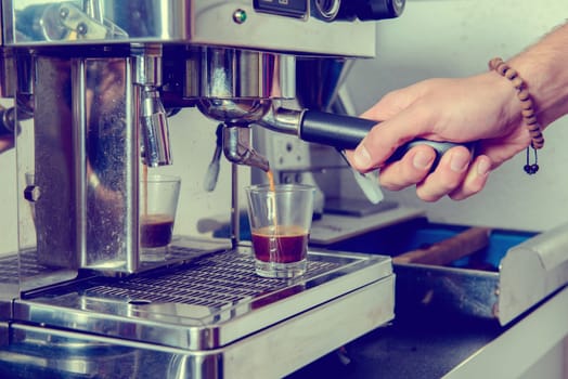 man using espresso metallic machine with portafilter