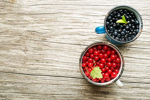 Blueberries and red currant on wooden background