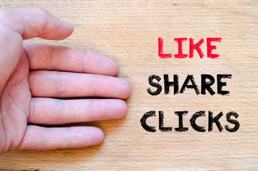 Human hand over wooden background and like share clicks text concept