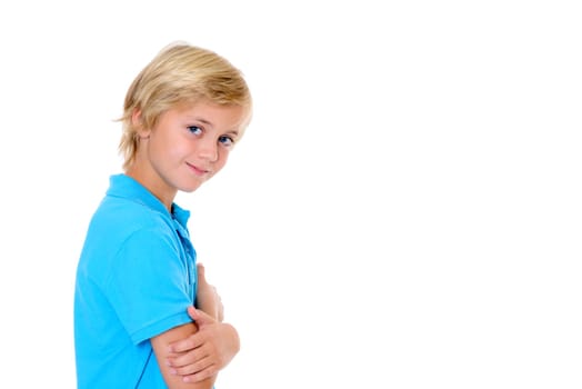 smiling blond boy with crossed arms in front of white background
