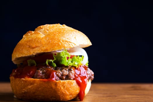 home made hamburger with meat, salad, onion, tomato and ketchup