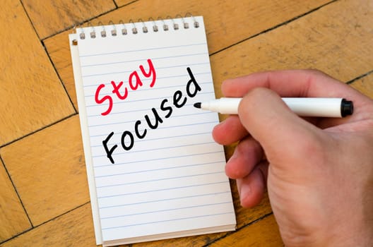 Stay focused text concept write on notebook