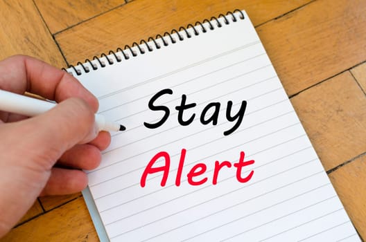 Stay alert text concept write on notebook