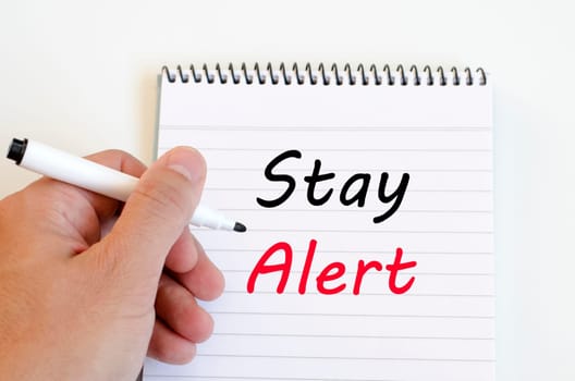 Stay alert text concept write on notebook