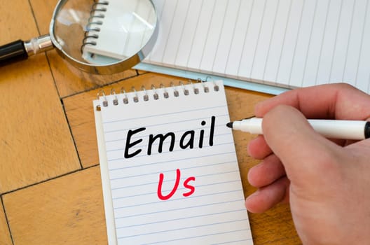Email us text concept write on notebook