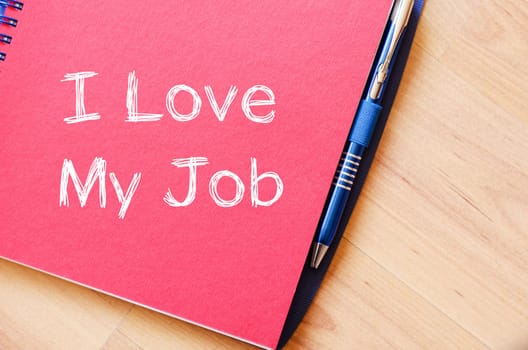 I love my job text concept write on notebook