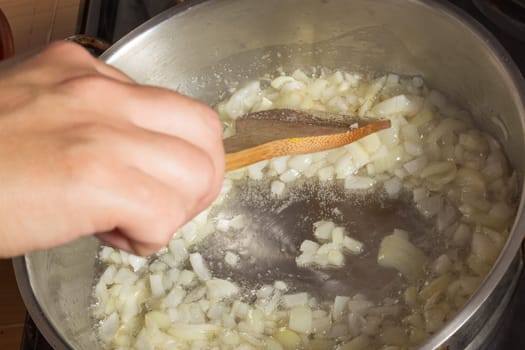 Frying chopped onion in a pan