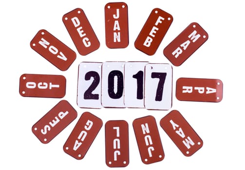 2017 year symbols and red month tiles around the date. Isolated on a white background