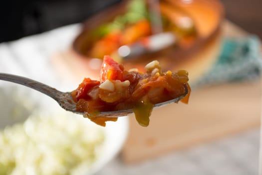 Spoon with vegetable stew with blurred background