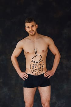 Man posing with a drawing of healthy intestines on his torso.