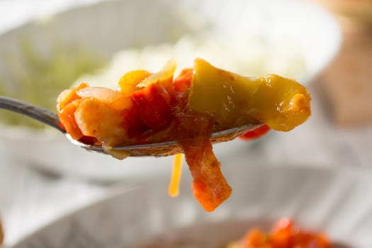 Spoon with vegetable stew with blurred background