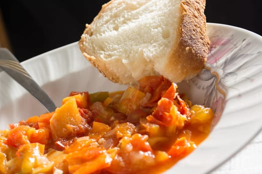 Closeup of vegetable stew with bread on a plate