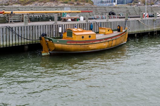 one old boat of wood in the harbour waiting to come up for the winter