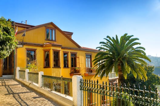The house rests on a steep hill above the port in Valparaiso, Chile