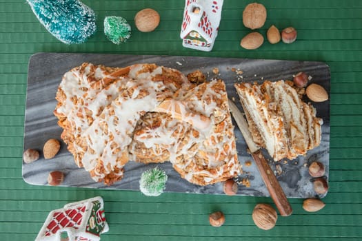 Homemade nut braid with various nuts and Christmas decorations